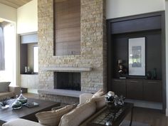 a living room filled with furniture and a fire place in the middle of a room