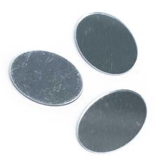 three metal discs on a white background