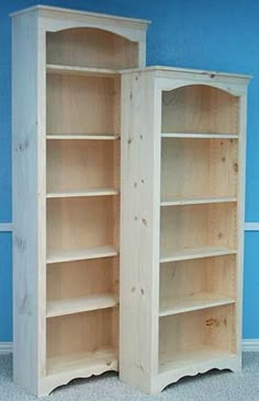 two wooden bookshelves sitting next to each other in a room with blue walls