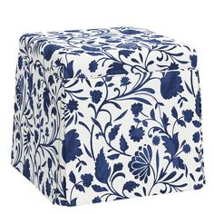 a blue and white ottoman cover with floral designs on it's sides, sitting in front of a white background