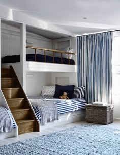 bunk beds with blue and white bedding in a child's bedroom, including a teddy bear