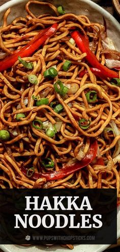 a white plate topped with noodles covered in sauce and green onions next to chopsticks