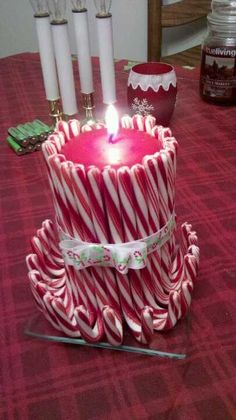 a candle that is on top of some candy canes