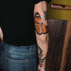 a woman with a butterfly tattoo on her arm