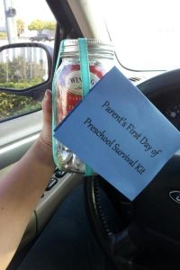 a person holding up a note attached to a car steering wheel