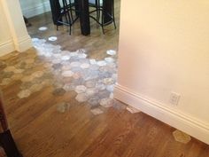 the floor is littered with rocks and water in this kitchen, as well as two bar stools