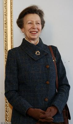 an older woman standing in front of a mirror smiling at the camera with her hand on her hip