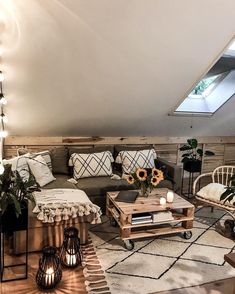 a living room filled with lots of furniture next to a skylight in a loft