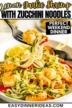 a white bowl filled with shrimp, zucchini noodles and garnishes