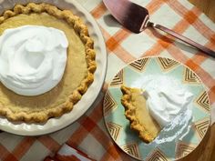 two pies on plates with whipped cream on top