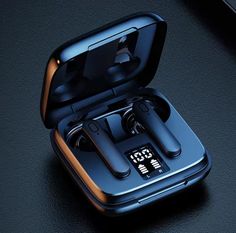 an image of two earbuds in the case on top of a black surface