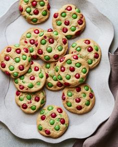 chocolate chip cookies with m & m's and candy chips on a white plate