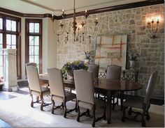 the dining room table is surrounded by beige chairs and upholstered with chandeliers