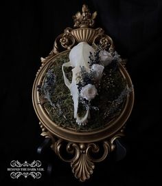 a mirror with a cow skull and flowers in it