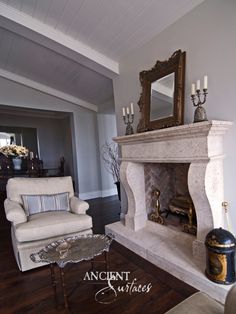 a living room filled with furniture and a fire place next to a mirror on the wall