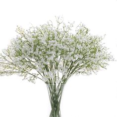 a glass vase filled with white flowers on top of a table