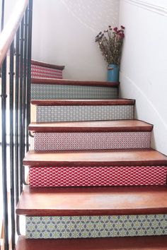 a set of stairs leading up to a vase with flowers in it on the other side