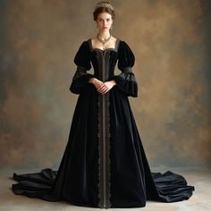 Discover the opulence of 16th-century England with this elegant Tudor-era inspired dress. Featuring a fitted, corseted bodice and loose, flowing sleeves, this floor-length gown is adorned with intricate embroidery and ornate gold trimming. The rich, velvety black fabric with a subtle sheen creates a slender, refined silhouette, complete with a delicate train and beaded lace trim. The soft, muted background in warm, earthy tones enhances the dress’s regal sophistication and understated elegance, making it a timeless piece for any historic-themed occasion.#TudorEraFashion #ElegantGown #FloorLengthDress #HistoricalCostume #RegalElegance #CorsetedBodice #IntricateEmbroidery #GoldTrimming #VelvetyBlackDress #16thCenturyStyle #VintageFashion #LuxuryDress #HistoricalDress #GownWithTrain Dark Rennaisance Outfits, Victorian Royalty Dress, Regal Ball Gown, Black Victorian Dress Aesthetic, Tudor Era Aesthetic, Medival Dresses Aesthetic, Victorian Royal Dress, 1200s Fashion, 1600s Dress