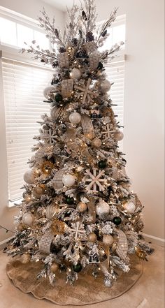 a christmas tree with silver and gold ornaments