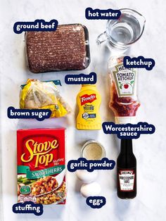 ingredients needed to make an entree laid out on a marble counter top, including eggs, ground beef, mustard, broth, and seasoning