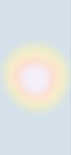 a blurry image of a circular object on a light pink background with blue and green colors