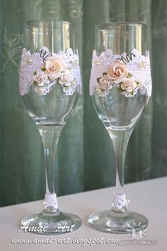 two wine glasses with lace and flowers on them