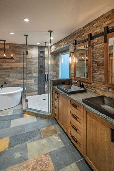 a large bathroom with a walk in shower next to a bathtub and sink area