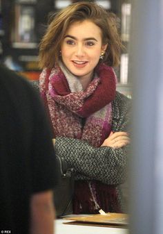 a woman wearing a scarf and smiling at the camera