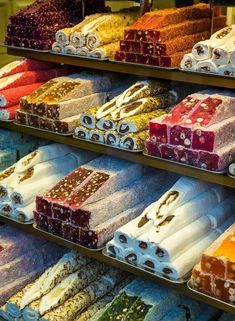 many different colored desserts are on display