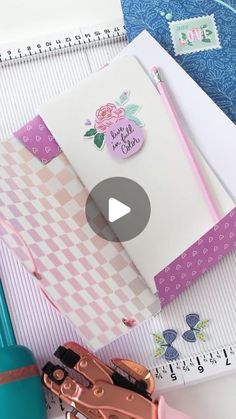 a video demonstrating how to make a scrapbook with paper and crafting supplies on it