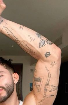 a man with many tattoos on his arm