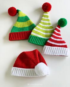 three knitted christmas hats with pom - poms