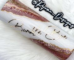 a white and gold glittered tube with the words hello little bron written on it