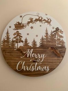 a wooden clock that says merry christmas with santa flying through the sky and reindeer on his sleigh