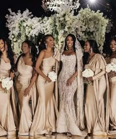 the bridesmaids are all dressed in champagne colored gowns