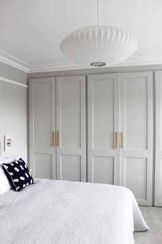 a white bed sitting in a bedroom next to closets