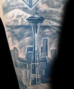 a man's arm with an image of the space needle on it