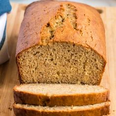 sliced loaf of banana bread sitting on top of a wooden cutting board