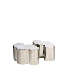 two silver and white side tables sitting next to each other