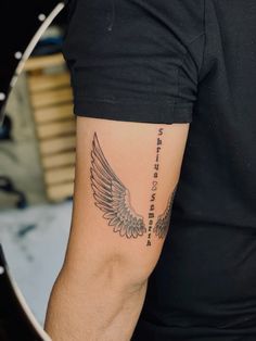 a man with a tattoo on his arm has an angel and the words, i love you