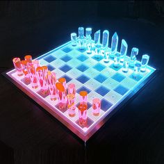 a lighted chess board with cups on it