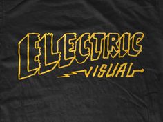 a black shirt with yellow lettering that says electronic visual on the front and back side