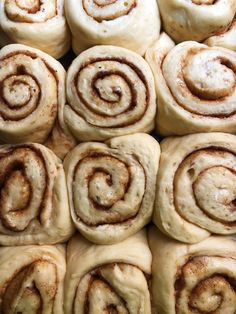 several cinnamon rolls stacked on top of each other in a pan with cinnamon swirl toppings