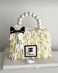 a cake with white frosting roses and a black bow