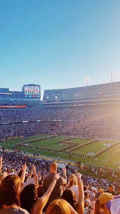 a stadium filled with lots of people watching a football game