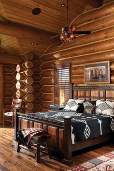 a bedroom with wooden walls and flooring has a large bed in the middle of it