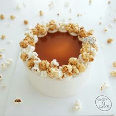 a white bowl filled with caramel and popcorn