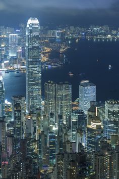 an aerial view of the city lights and skyscrapers in hong kong, china at night