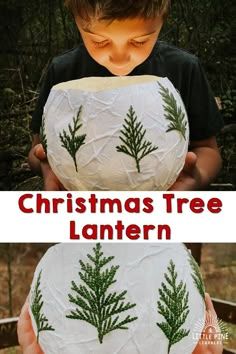 a young boy holding a paper mache with christmas trees on it and the words christmas tree lantern