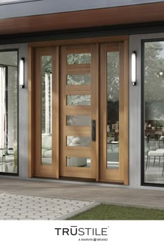 the front door of a house with glass and wood